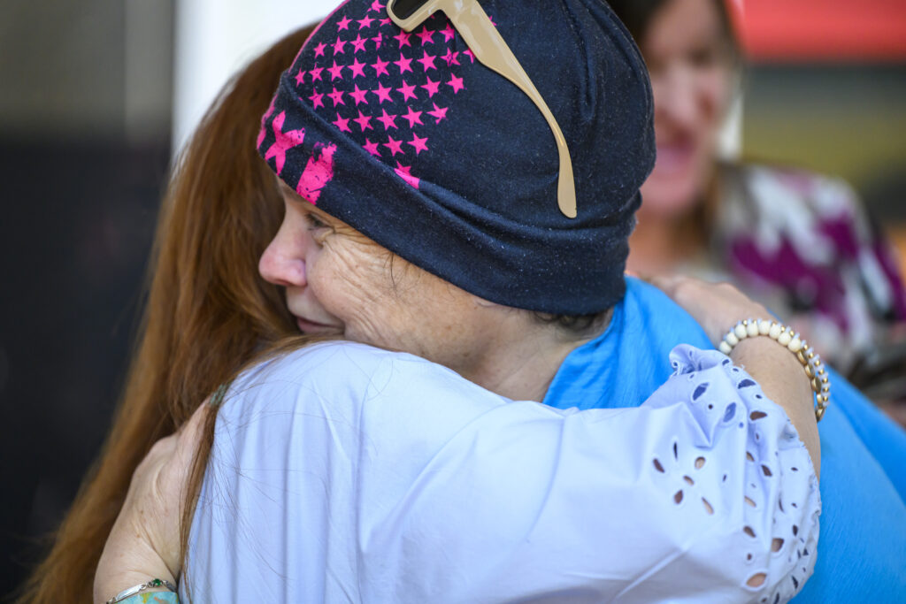 Two individuals hugging at Infinite Legacy's Ceremony of Remembrance.